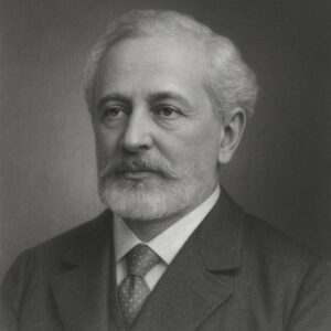 Porträt von Leopold Auerbach (1828–1897) in Schwarz-Weiss, mit hellem Haar, gepflegtem Bart, Anzug und Krawatte, in ruhiger Pose vor neutralem Hintergrund.